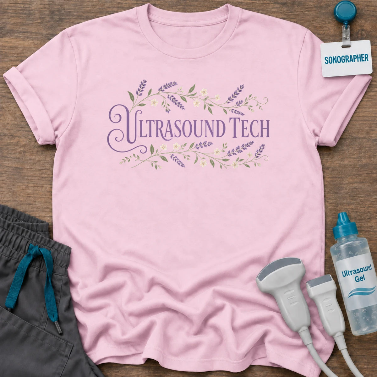 Lavender Floral Ultrasound Tech t-shirt with “Ultrasound Tech” in purple serif lettering framed by lavender sprigs and small white flowers, in Light Pink, by Sono Graphics