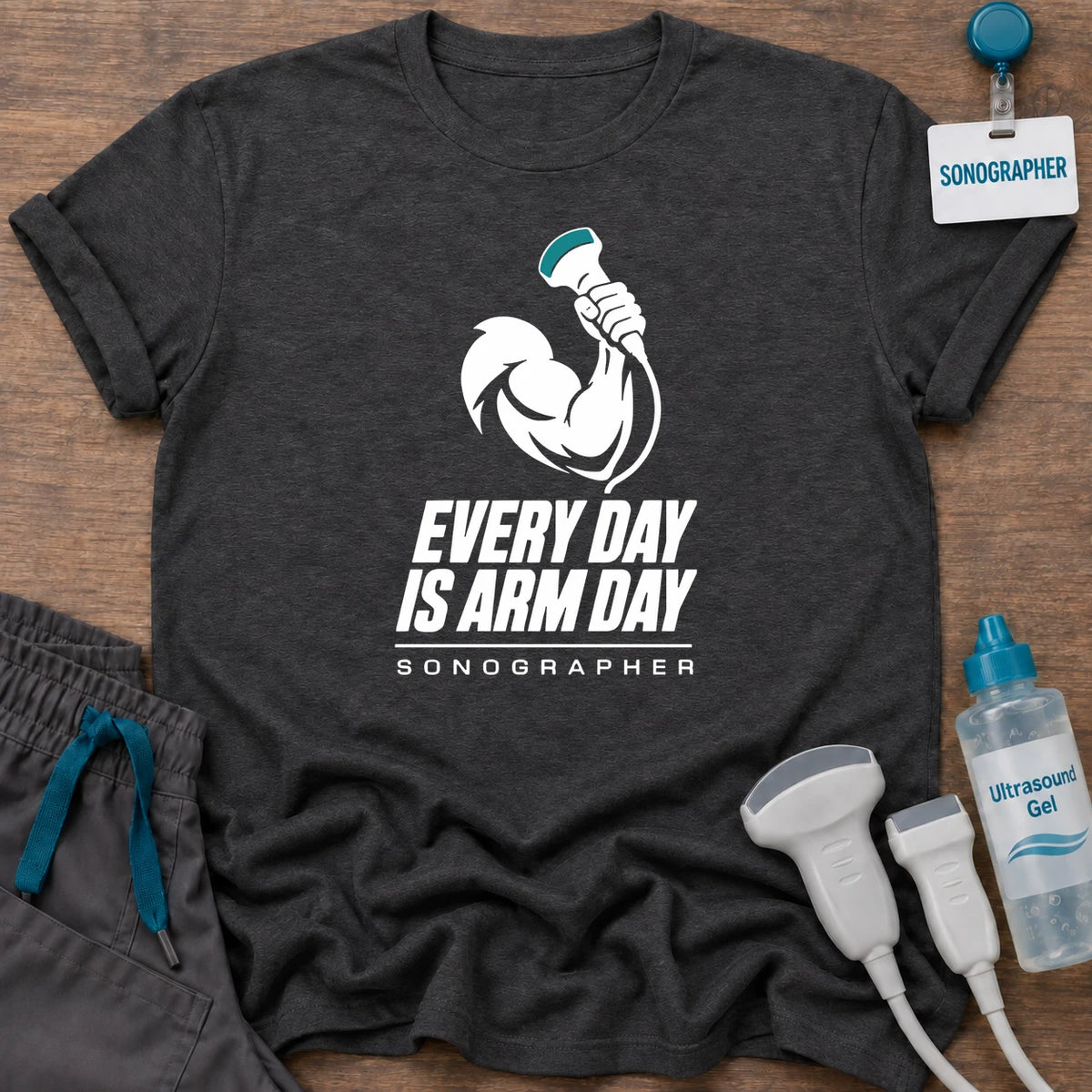 Arm Day Male Sonographer t-shirt with a muscular flexed arm gripping an ultrasound probe above the words “Every Day Is Arm Day, Sonographer”, in Dark Heather, by Sono Graphics