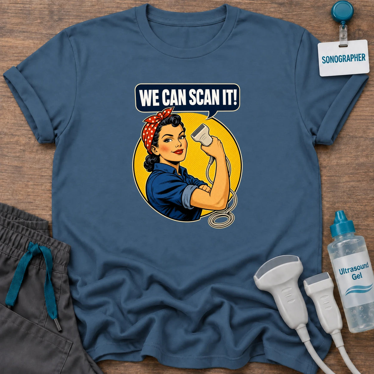 Retro We Can Scan It sonographer t-shirt with a retro Rosie the Riveter-style sonographer flexing while holding an ultrasound probe under a “We Can Scan It!” speech bubble, in Indigo Blue, by Sono Graphics