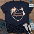 OB Sonographer Floral Heart t-shirt with a heart drawn by a transducer cord with blush flowers, a butterfly and “Obstetrical Sonographer” in peach script, in Navy, by Sono Graphics