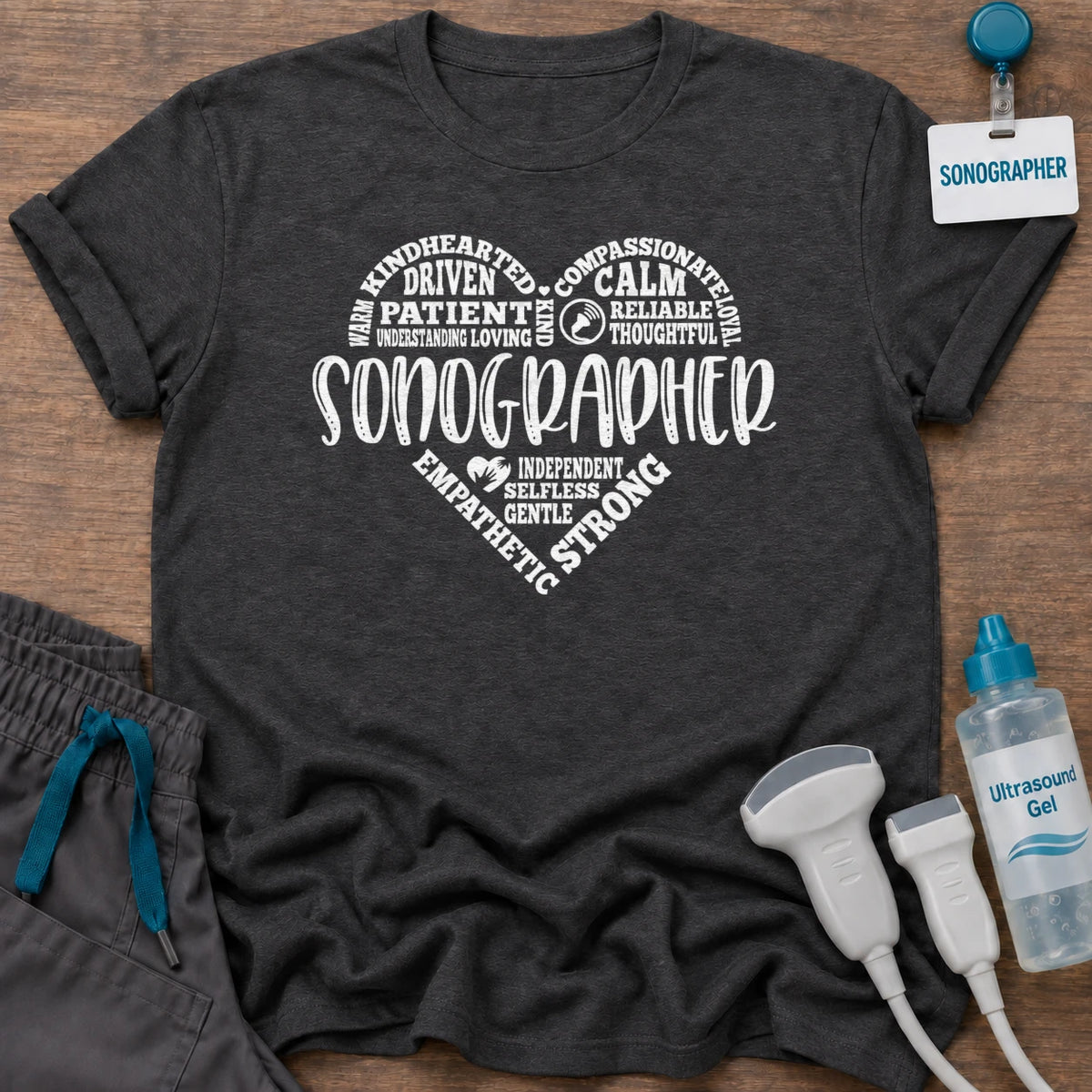 Sonographer's Heart t-shirt with a heart made of words like patient, calm, compassionate and strong around SONOGRAPHER, in Dark Heather, by Sono Graphics