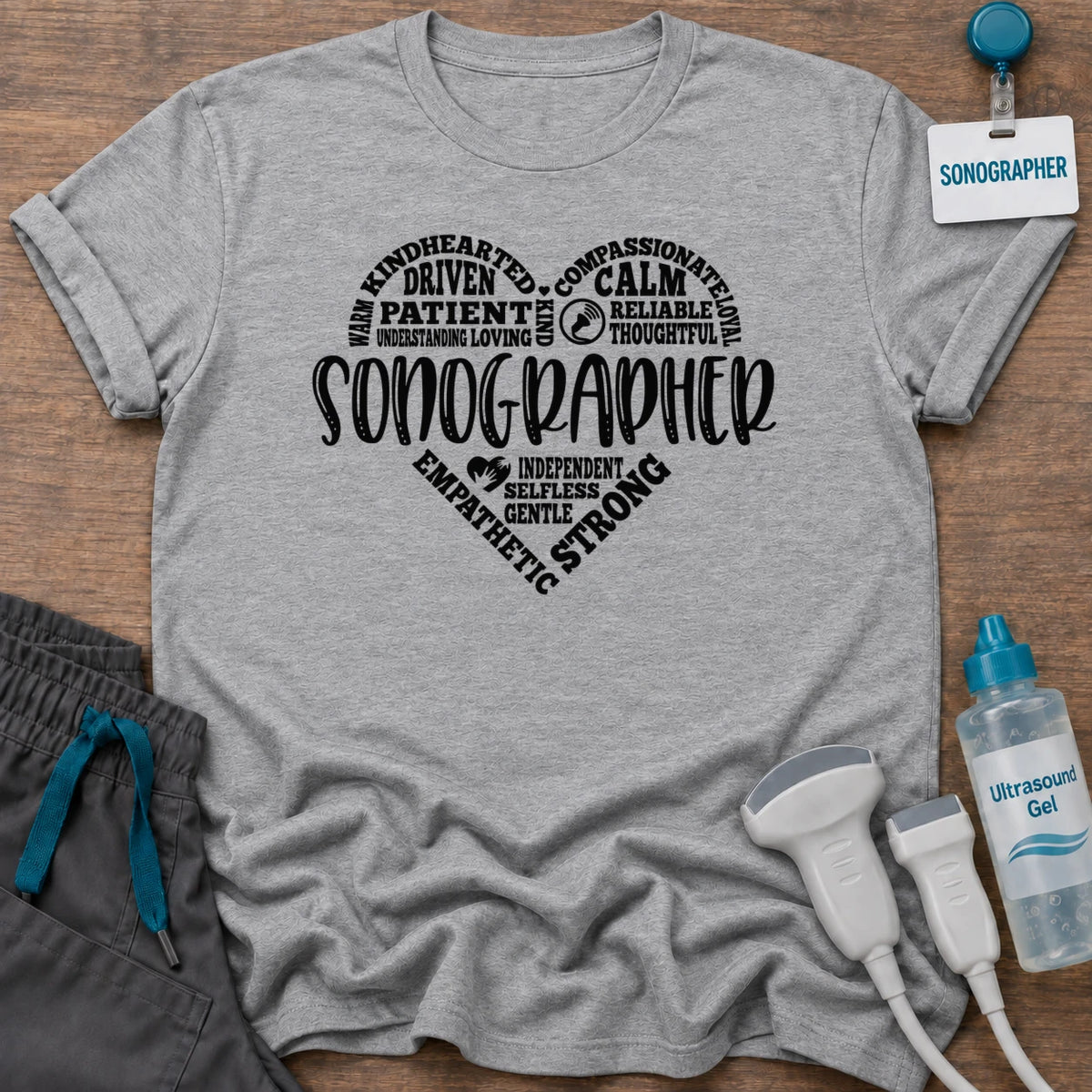 Sonographer's Heart t-shirt with a heart made of words like patient, calm, compassionate and strong around SONOGRAPHER, in Sport Grey, by Sono Graphics