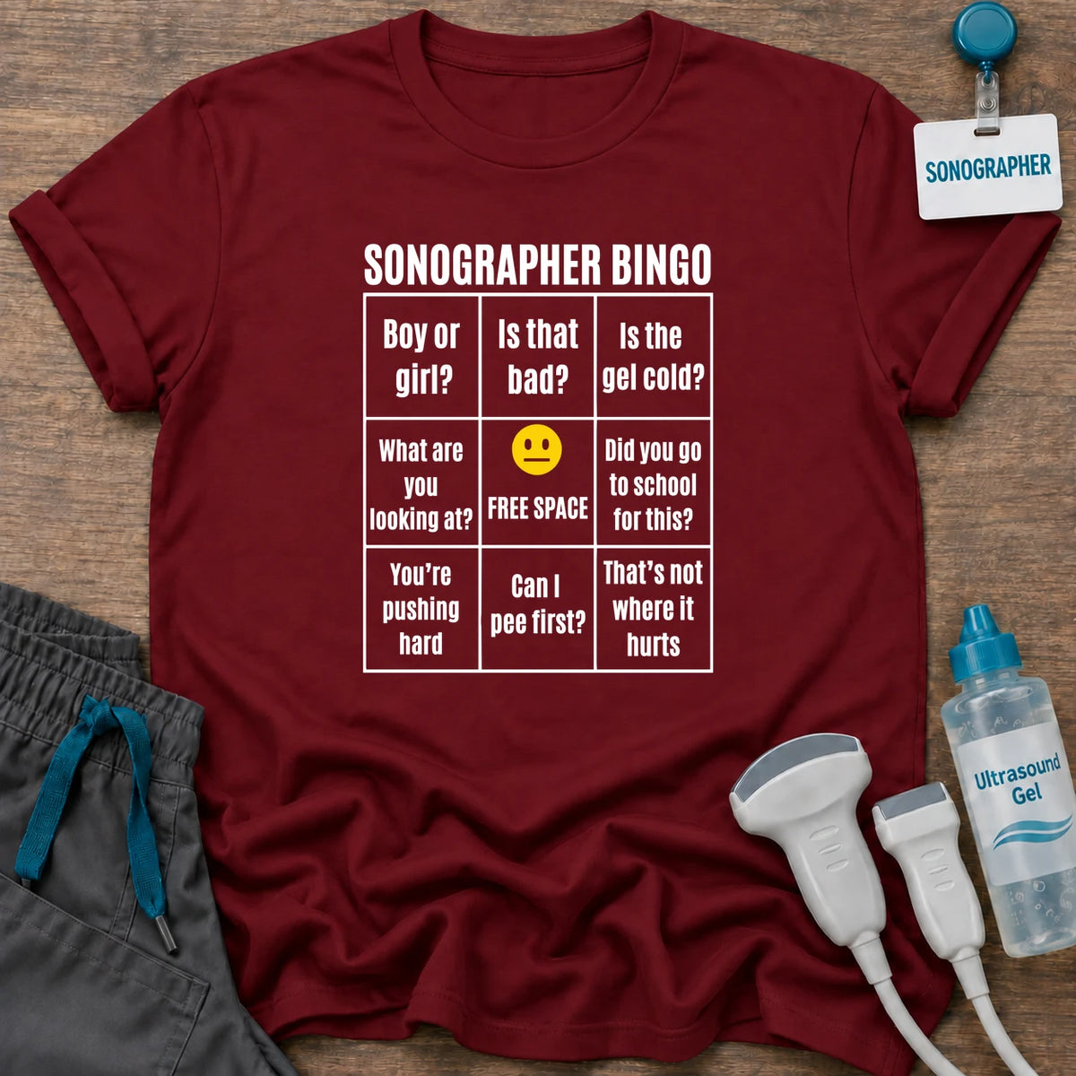 Sonographer Bingo t-shirt with a “Sonographer Bingo” card of things patients say, like “Boy or girl?”, “Is that bad?” and “Can I pee first?”, in Cardinal Red, by Sono Graphics